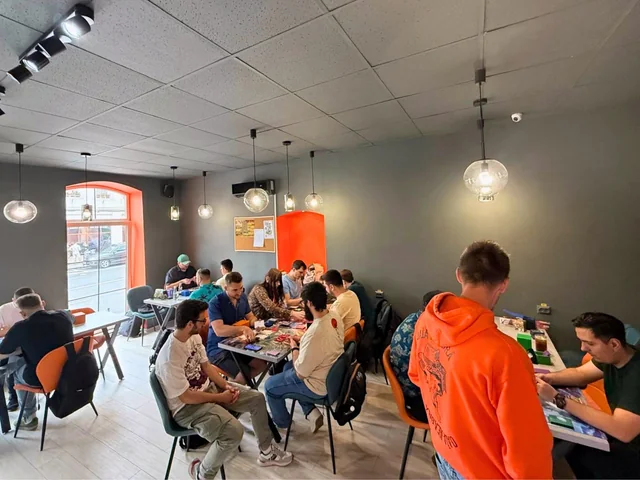 The KRIT Brașov game room with players at tables beside the windows